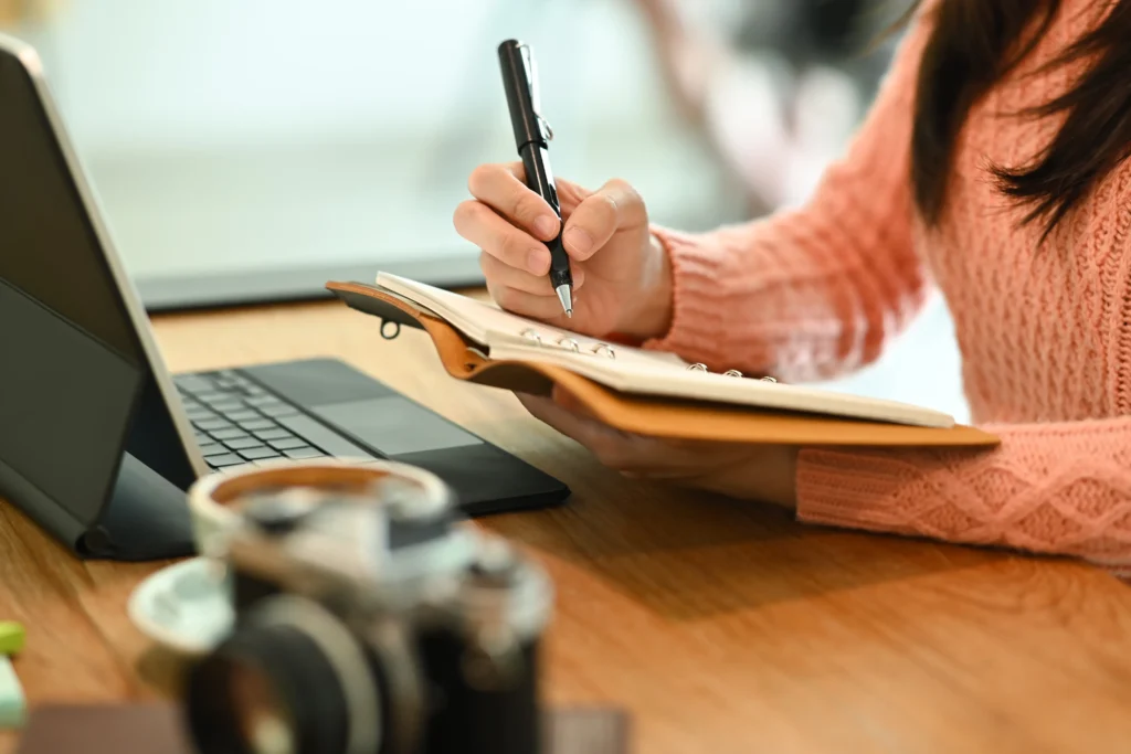 cropped shot young woman holding pen and writing h 2024 11 25 16 23 45 utc